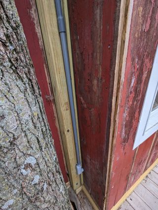 Conduit comes out of the cabin in the corner